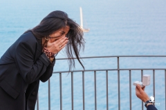 Couple celebrating their wedding proposal Isola Bella at sunset