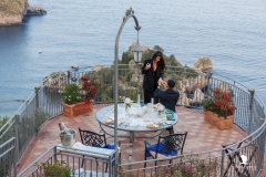  "Beginning of an Isola Bella marriage proposal: the couple walks down the terrace with a breathtaking view"