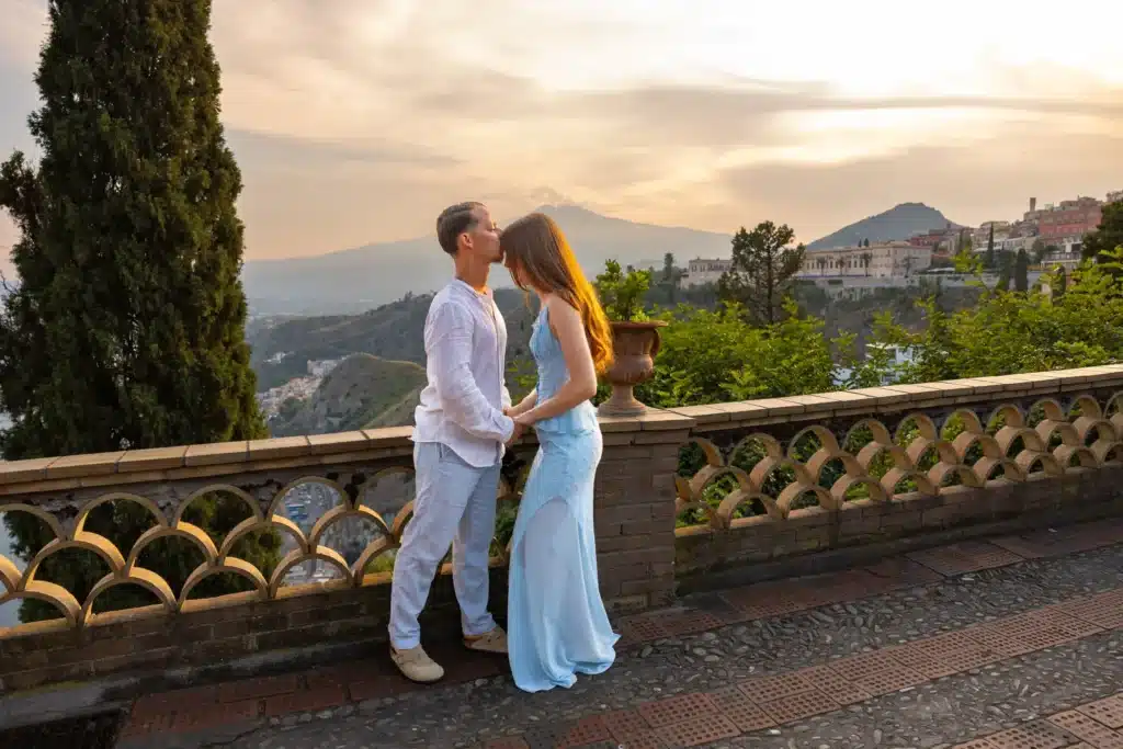 Couple embracing after a marriage proposal in Sicily with Mount Etna behind them